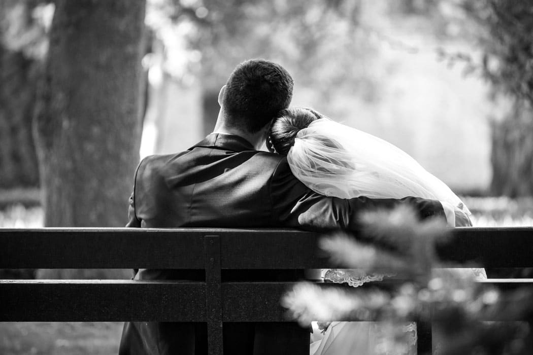 Instantaneu surprins de fotograf nunta in Bucuresti: mireasa cu capul pe umarul mirelui, pe banca.